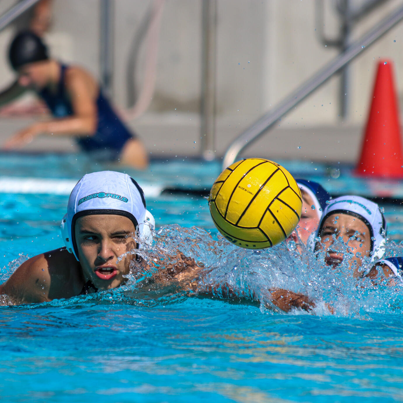 Fast-paced water polo action shot in a competitive game.