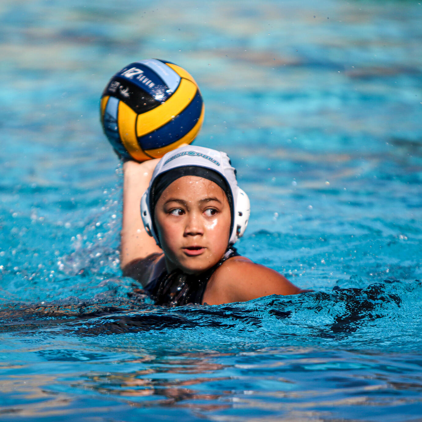 Intense water polo action shot during a competitive match.