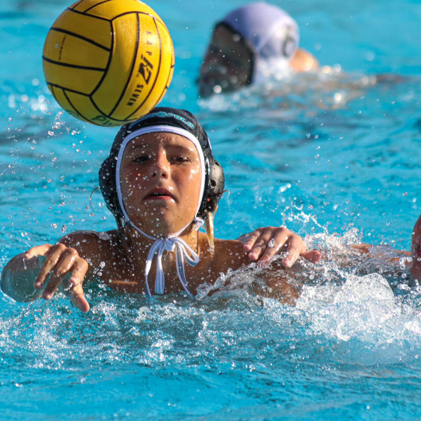 Water polo player executing a swift steal in the water.
